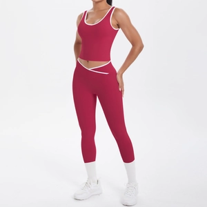 Close-up of red yoga set with white trim featuring a V-cross high waist design