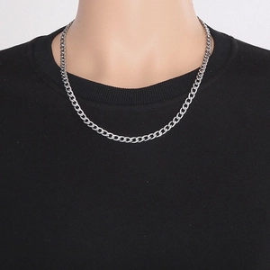 Detail of 6mm thick silver Cuban chain necklace on neck with 55cm length specification