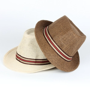 Close-up of beige and brown straw Panama hats with striped ribbon and woven texture
