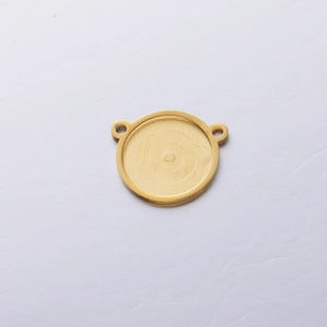 Detail view of round golden stainless steel pendant base with double hanging loops