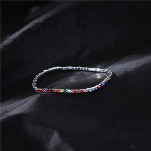Detail shot of 2mm rainbow crystal elastic bracelet on black satin silk background