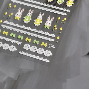 Detailed 3D embossed nail stickers featuring cute cartoon rabbits and lace flowers