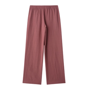 Detail of dusty rose wide-leg pants with an elastic waist and textured fabric