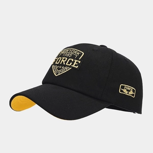 Detail view of premium black baseball cap with high-quality yellow shield embroidery on front
