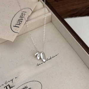 Minimalist 925 sterling silver necklace with three polished oval bean pendants in a box