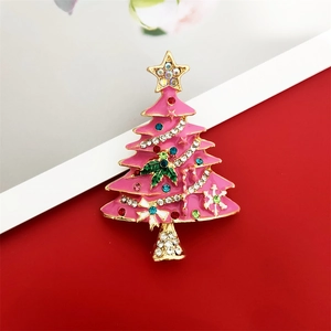 Detail of pink enamel Christmas tree brooch with colorful rhinestones and gold plating