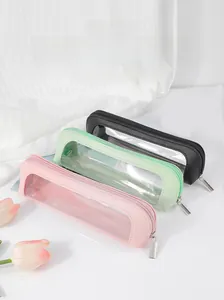 Three travel makeup brush pouches in pink, green, and black with transparent PVC windows
