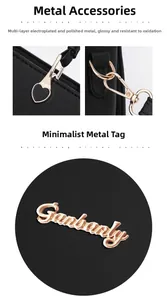 Detail of gold-plated hardware and heart charm on black leather handbag for women
