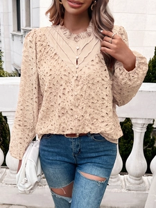 Close-up of beige hollow lace top with V-neck ruffle trim and button front detail