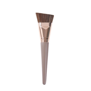 Angled foundation brush with soft brown bristles and elegant beige wooden handle