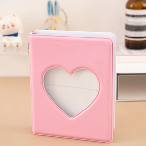 Close-up of pink 3-inch photo album with a heart-shaped window and a glossy vinyl finish