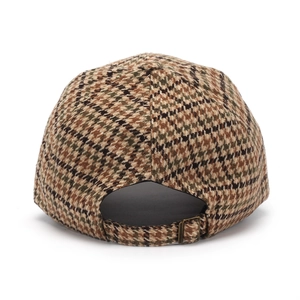 Close-up of houndstooth baseball cap featuring a metal buckle adjustment and wool fabric