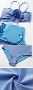 Detailed close-up showing 3D floral petals, inner pads, and textured fabric of the blue swimsuit