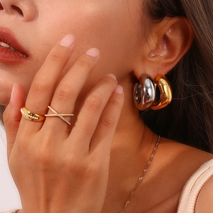 Minimalist gold and silver hollow square earrings and rings set on a female model