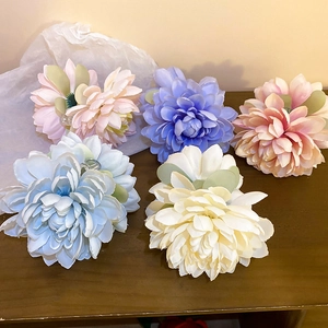 Handmade fabric lotus hair claws in pink, purple, and blue colors for elegant styling