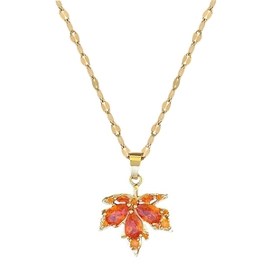 Maple leaf pendant necklace in gold stainless steel with vibrant orange-red gemstones