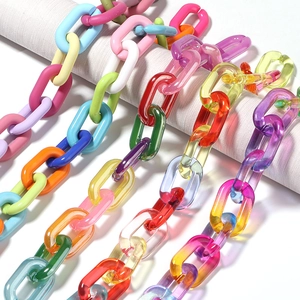 Detailed close-up of colorful macaron and gradient acrylic chains for DIY jewelry making