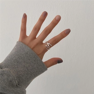 Detail shot of irregular fluid lava texture on 925 sterling silver ring worn on finger