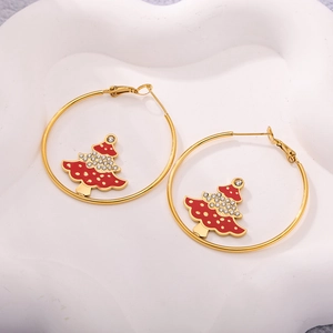 Detailed close-up of golden hoop earrings with rhinestone-encrusted Christmas tree pendants