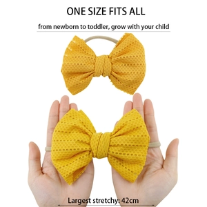 Elastic yellow hollow mesh baby headband with bow, stretching up to 42cm circumference