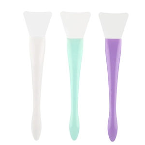 Detail view of three colorful silicone face mask brushes with wide flat fan heads