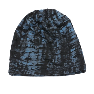 Detailed knit texture and distressed hole design on a black and blue tie-dye slouchy beanie