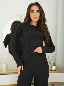 Close-up of black long-sleeve pajamas set featuring comfortable crewneck top and pants
