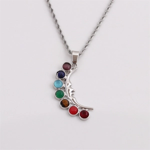 Silver crescent moon face necklace with seven colorful chakra gemstones on a twist chain