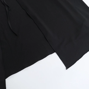 Macro shot of black fabric texture with drawstring detail and side slit of the dress