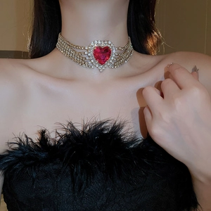 Detailed view of luxury gold multi-layer rhinestone choker with red heart centerpiece