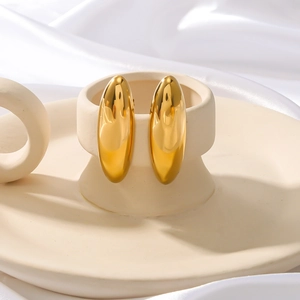 Elegant 18K gold plated stainless steel teardrop earrings on a ceramic display pedestal