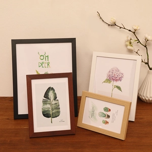 Modern wood picture frames set in black, white, and natural oak finishes for wall and tabletop