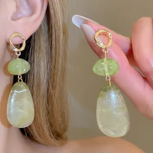 Irregular green resin teardrop earrings with gold metal accents for a vintage look