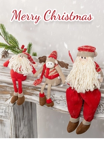 Three plush Christmas dolls including Santa and Reindeer sitting on a wooden mantelpiece