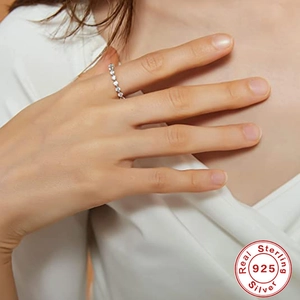 Detailed close-up of a 925 sterling silver diamond ring on a finger with certification mark
