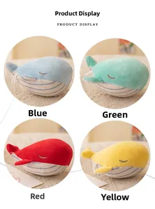 Detail of colorful whale plush keychains in blue green red and yellow fabric