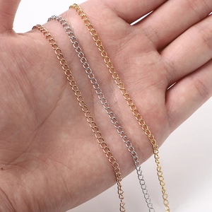 Hand holding adjustable 18k gold plated stainless steel extension chains in three colors