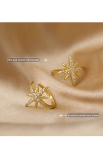 Macro detail of gold-plated star ear cuff with sparkling hand-set white zircon stones