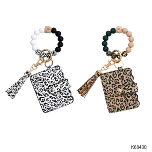 Detail of leopard and spotted silicone bead wristlets with leather wallet and tassels