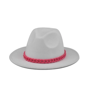 Detail of white felt fedora hat featuring a chunky vibrant pink chain link band accent