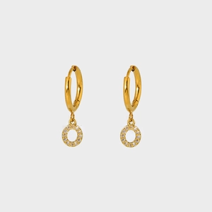Detailed macro view of gold plated earrings featuring circular zircon micro-pave charms
