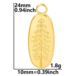 Macro view of golden stainless steel oval pendant with embossed pine tree pattern detail