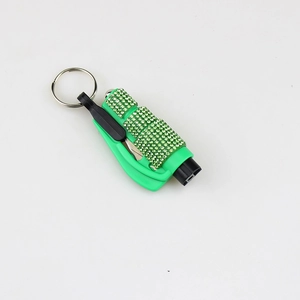 Close-up of green rhinestone keychain tool with built-in folding blade and metal ring