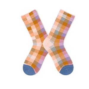 Detailed flat lay of colorful plaid cotton socks with an X-shaped cross display