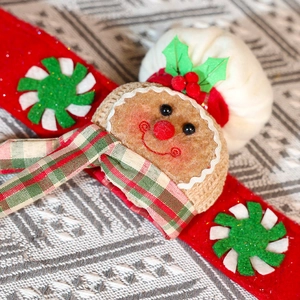 Detail of gingerbread man curtain buckle with plush texture and peppermint candy pattern