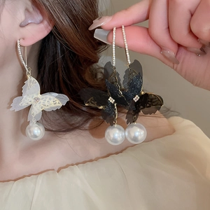 Detail of mesh butterfly earrings with pearl drops and sparkling rhinestones for women