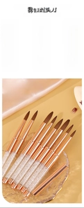 Macro shot of professional crystal nail brushes with glitter acrylic handles in a rose gold ferrule