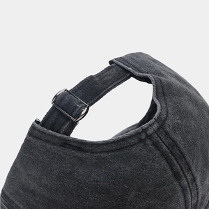 Close-up of the adjustable strap and metal buckle on a vintage washed baseball cap