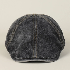 Detail view of washed denim flat cap showing stitching and retro gray vintage fabric