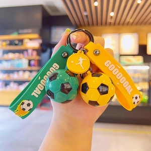 Green and yellow soccer ball keychains with GOAL wrist strap and football charms